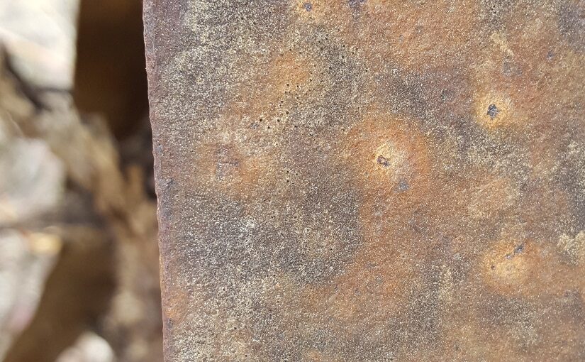 Strip of weathered metal, curving into background