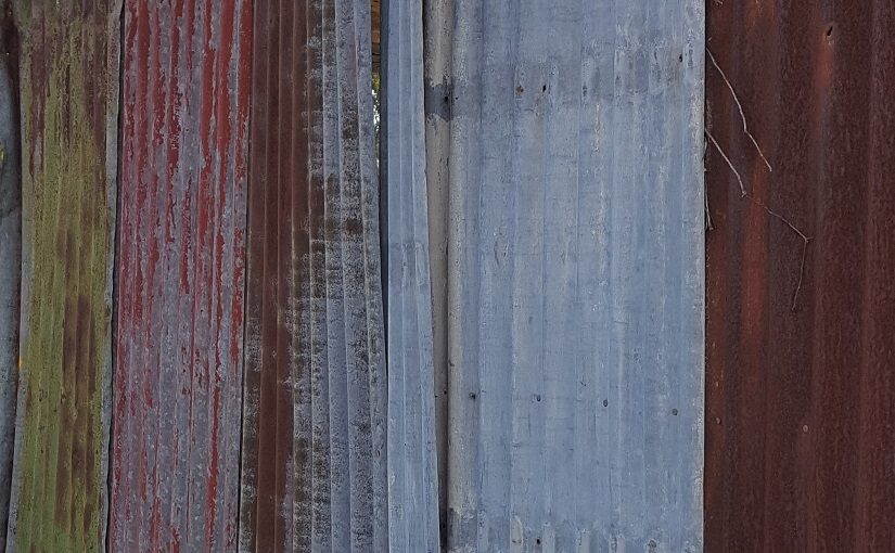 Faded coloured panels on a metal shed