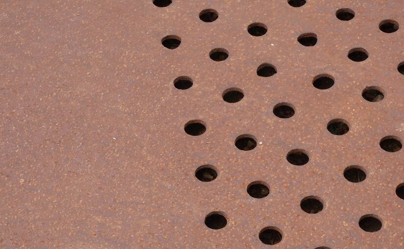Holes punched across metal